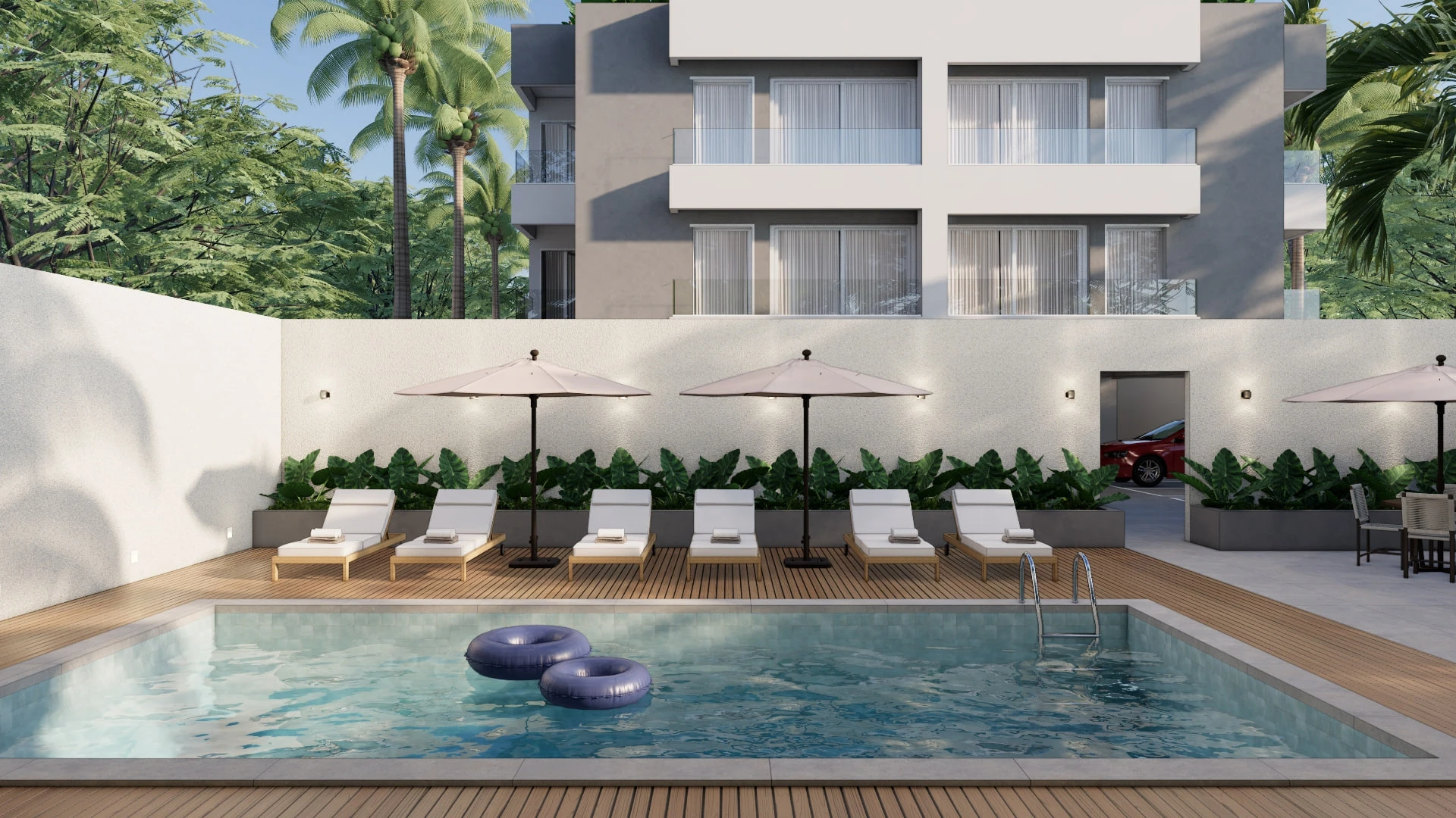 Piscina com deck e espreguiçadeiras nos fundos do Enseada Exclusive, Praia da Enseada, Guarujá